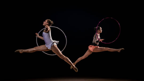 istock Gymnasts doing rhythmic gymnastics with hoop 1157901653
