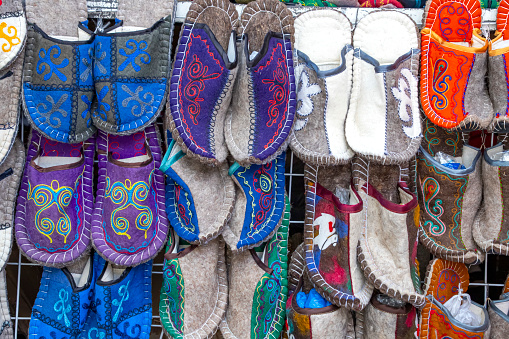 Handmade oriental slippers made of felt with a national ornament closeup. Market. Travel. Kyrgyzstan