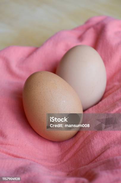 Eggs On Pink Fabric Stock Photo - Download Image Now - Animal Egg, Animal Shell, Brown