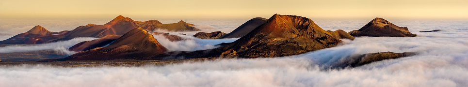 Volcanes en el parque nacional de Timanfaya en Lanzarote. Volcanes que salen de las nubes photo