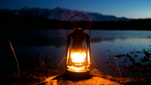 The old kerosene lantern hanging on Sunrise over Lake 4k