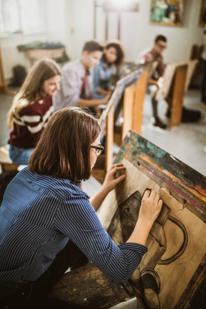 istock Female art student drawing a painting at art studio. 1157906943