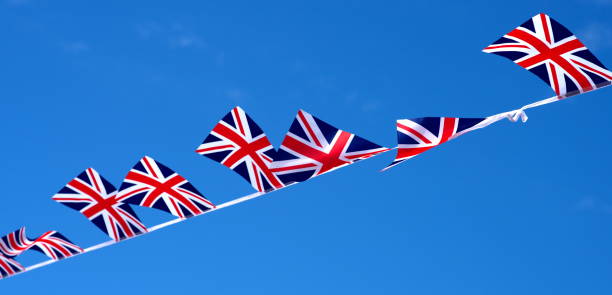 istock pretty many United Kingdom (UK) flags placed diagonal with bokeh and free space for your content - any celebration flag 3d illustration 1157907599