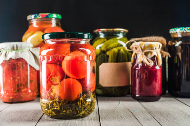istock Preserved vegetables on wooden background 1157908047