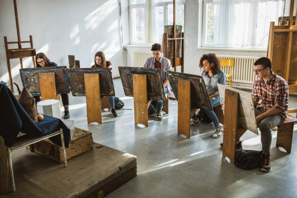 group of students drawing their paintings on a class at art studio. - women artist painting easel imagens e fotografias de stock