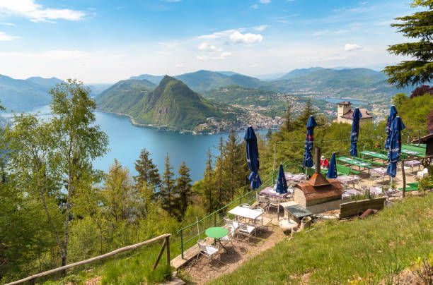 View of lake Lugano with Monte San Salvatore from a restaurant i Monte Bre, Lugano, Switzerland - May 7, 2019: View of lake Lugano with Monte San Salvatore from a restaurant in Monte Bre, Switzerland lugano stock pictures, royalty-free photos & images