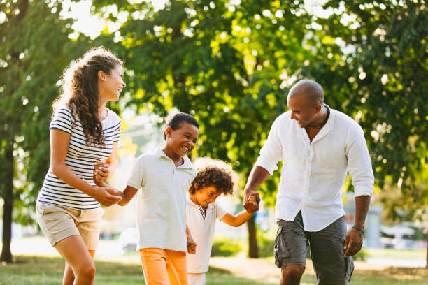 istock Happy couple spending time with their sons in the park 1157909385