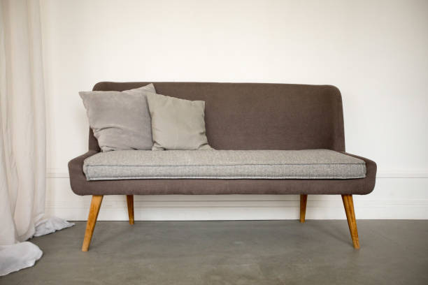 istock Simple brown and grey sofa with wooden legs 1157909821