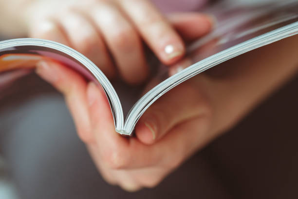 istock woman reading magazine at home 1157909878