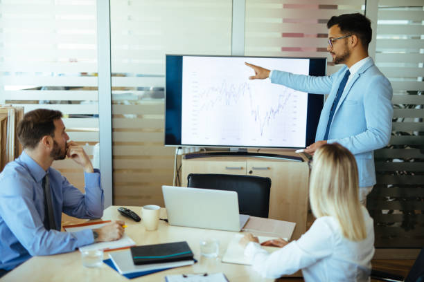 istock Businessman leading presentation in meeting room 1157910751