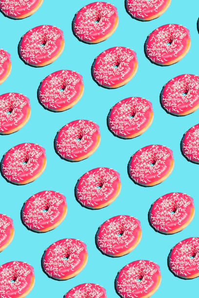 istock Creative poster with donuts. Donuts on a blue background. Flat lay Pattern of donut 45 degree, pop art. Pink glazed donut Creative concept. Minimal food Isometric. Abstract dessert 1157910913