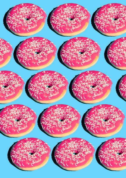 istock Creative poster with donuts. Donuts on a blue background. Flat lay Pattern of donut 45 degree, pop art. Pink glazed donut Creative concept. Minimal food Isometric. Abstract dessert 1157910943