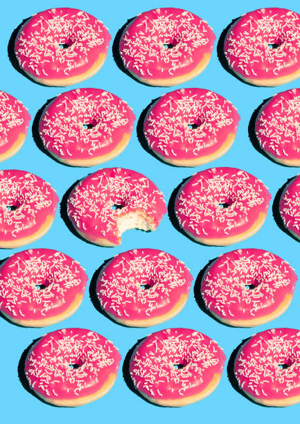 istock Creative poster with donuts. Donuts on a blue background. Flat lay Pattern of donut 45 degree, pop art. Pink glazed donut Creative concept. Minimal food Isometric. Poster for sale. 1157910944