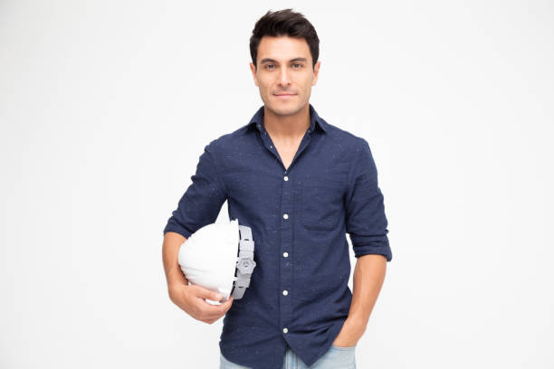 istock Handsome man industrial engineer holding a white helmet under his arm isolated on white background 1157911259