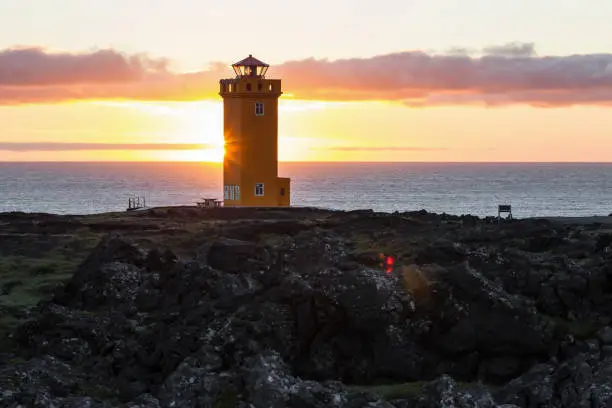 Photo of Svortuloft Lighthouse, Hellissandur in The Snaefellsjokull National Park, Snaefellsbaer, Iceland. Orange colorful sunset, good sunny weather.