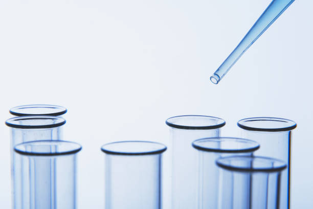 istock Pipette dropping liquid into cells of container 1157912588
