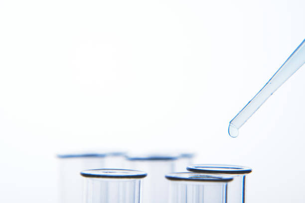 istock Pipette dropping liquid into glass tubes 1157912590