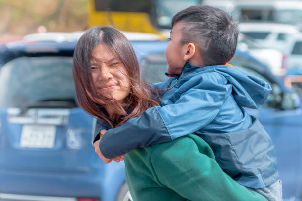 istock Japanese mother is carrying her son on her back 1157912867