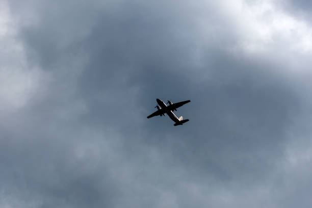 istock the plane flies across the blue sky 1157915984