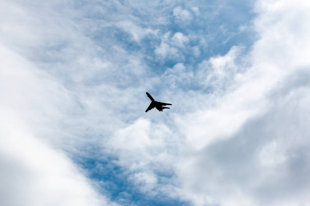 istock the plane flies across the blue sky 1157915991