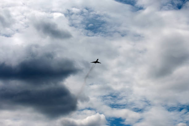 istock the plane flies across the blue sky 1157916009