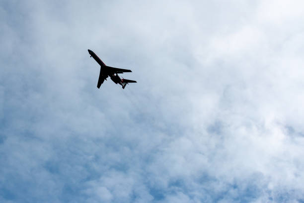 istock the plane flies across the blue sky 1157916010