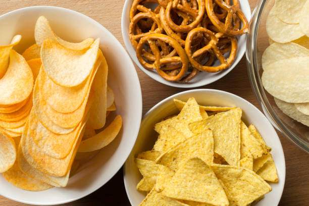 salty snacks. pretzels, chips, crackers - pretzel snack salty food imagens e fotografias de stock