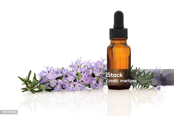 Closeup Of Rosemary Herbal Essence Oil And White Background Stock Photo - Download Image Now