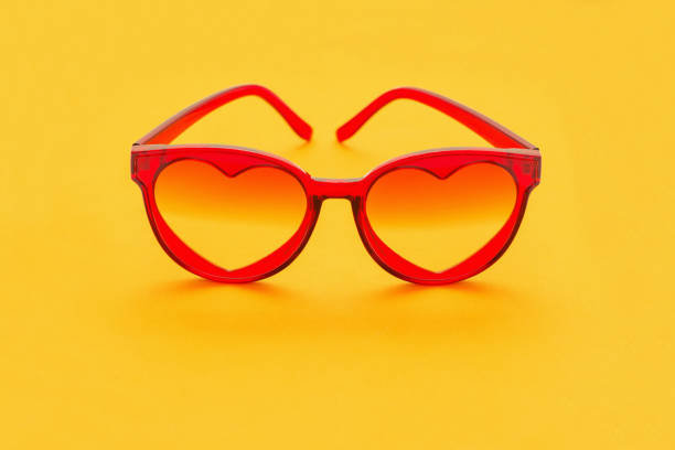 istock red sunglasses on yellow background 1157918587