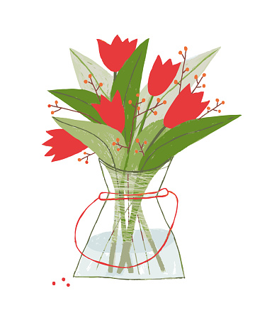 A bouquet of red tulips and orange berries in a glass vase with water.