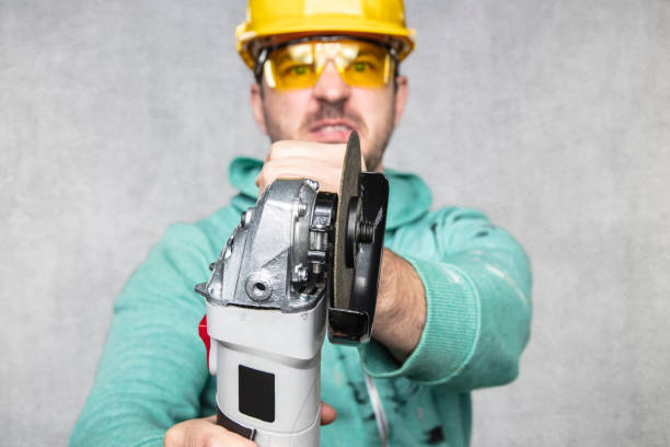 istock the construction worker holds an angle grinder in his hand 1157918993