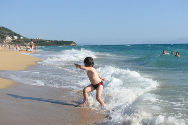 istock Happy little boy playing on the beach 1157919098