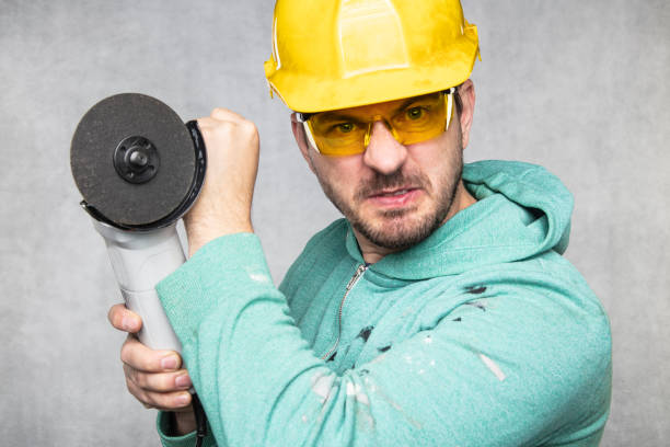 istock the construction worker holds an angle grinder in his hand 1157919114
