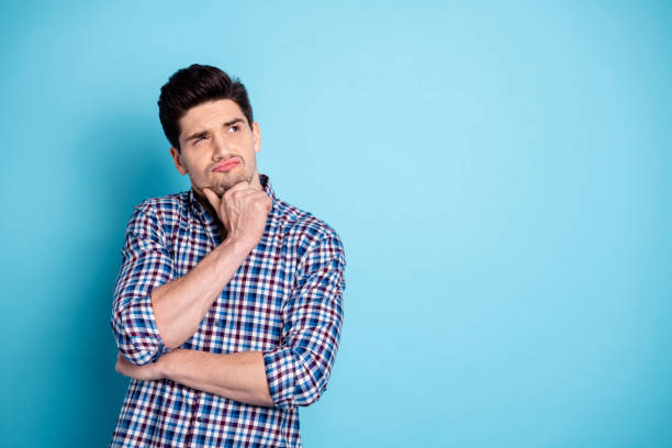 Close up photo amazing he him his macho look up empty space unsure doubtful arm touch chin think over business startup project wear casual checkered plaid shirt isolated bright blue background Close up photo amazing he him his macho look up empty space unsure doubtful, arm touch chin think over business startup project wear casual checkered plaid shirt isolated bright blue background deep pick stock pictures, royalty-free photos & images