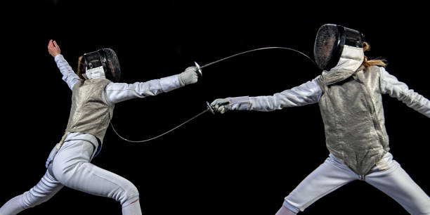 fencer athletes competing during a sporting event - fencing sport rivalry sword imagens e fotografias de stock