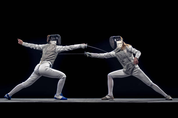 fencer athletes competing during a sporting event - fencing sport rivalry sword imagens e fotografias de stock
