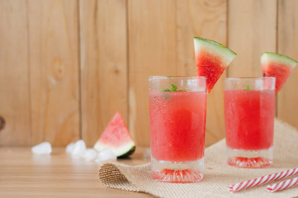 istock Fruit tropical with drink with spring summer holiday & vacation background concept.Arrangement items fresh ice watermelon  juice on modern brown wooden table.Copy space for design text & word. 1157924107