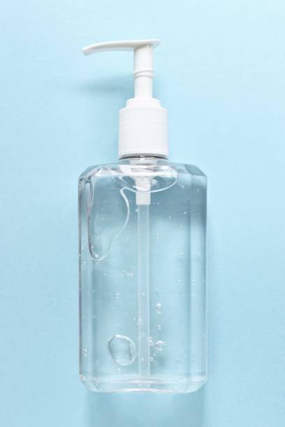 istock Close-Up Of Soap Dispenser Against Blue Background 1157929529