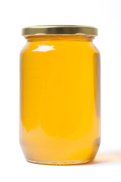 istock Herbal Honey in a Jar on White 1157929576
