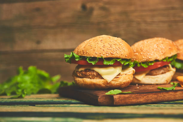 istock Craft beef burger  on wooden table isolated on black background. 1157929788