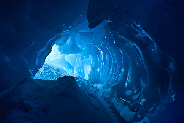 Beautiful blue ice cave with entrance visible stock photo