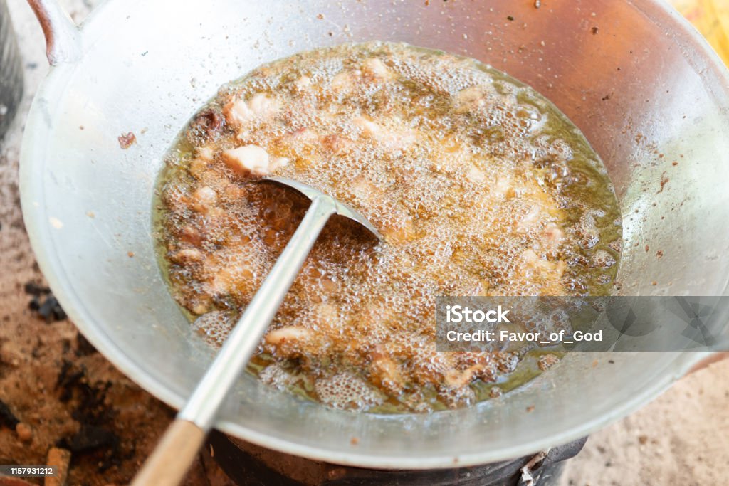 Fried lard oil homemade. Making Lard oil for cooking. Animal Stock Photo