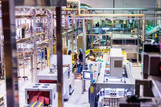 Industry, Business, Factory, Bottling Plant - Bottling Plant Factory Interior with Modern Machinery and Manual workers working near production line
