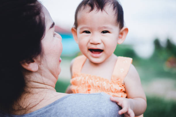 istock Mother raised her little baby on her shoulder 1157931757