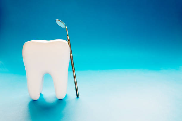 istock Close up big tooth and dentist tool. 1157931797