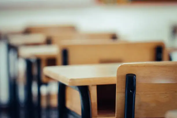 Photo of Back to school concept. School empty classroom, Lecture room with desks and chairs iron wood for studying lessons in highschool thailand without young student, interior of secondary education