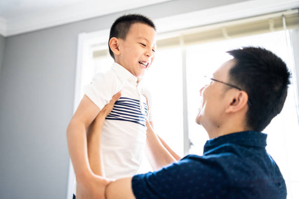 istock Asian father lifting up his son 1157933387