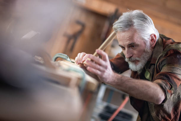 istock Carpenter measuring wooden plank in workshop 1157935251