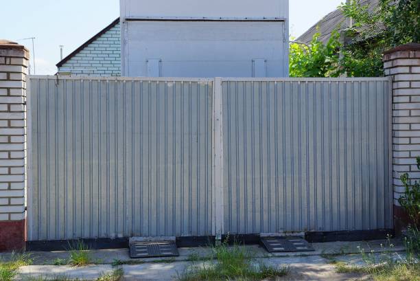 istock big gray metal gate on a rural street 1157940425