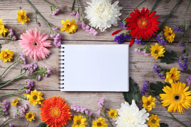 istock Colorful chrysanthemums placed on the table old wooden with book diary for text 1157940615
